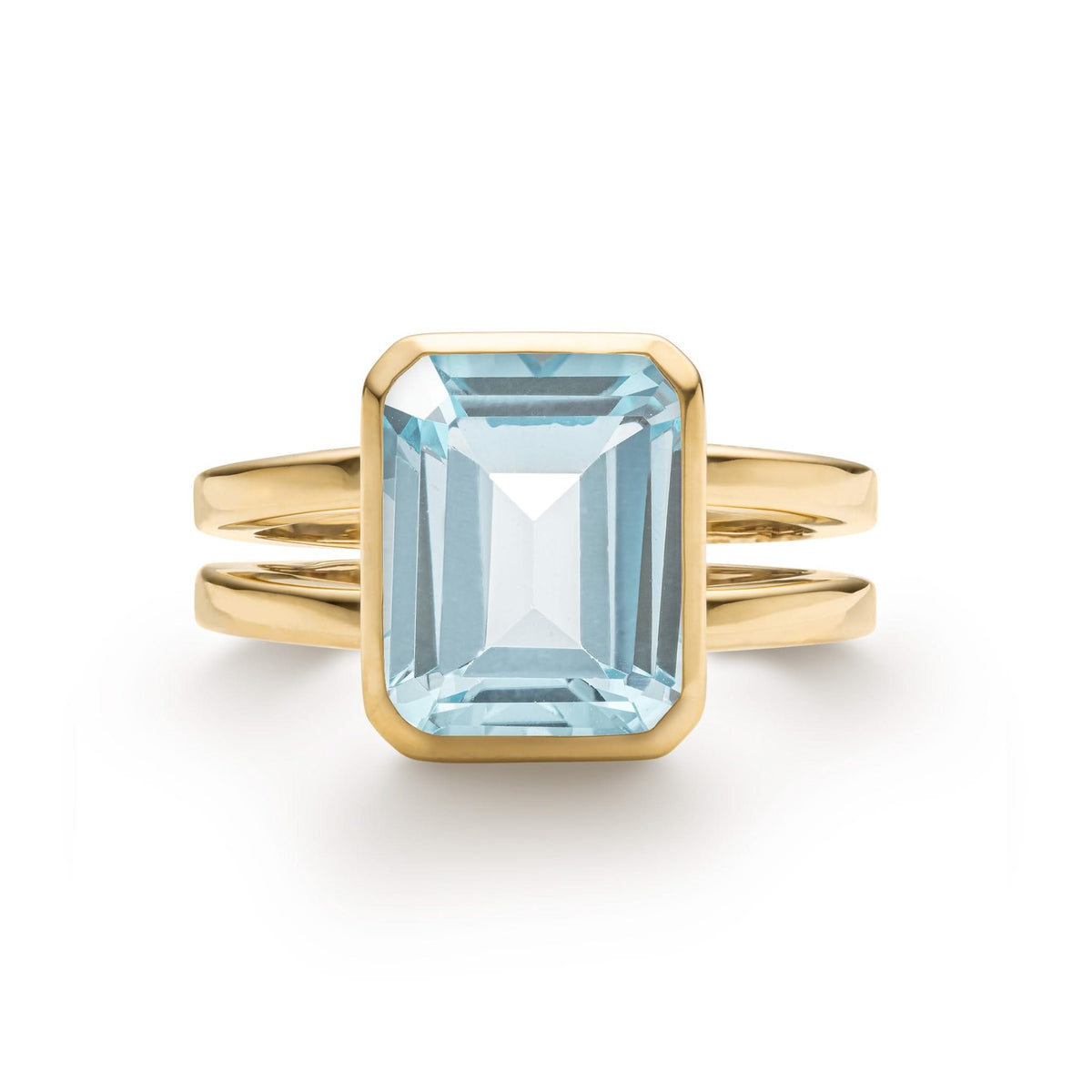 Warren ring in 14k yellow gold featuring one 10 x 8 mm emerald cut bezel set Nantucket blue topaz - front view