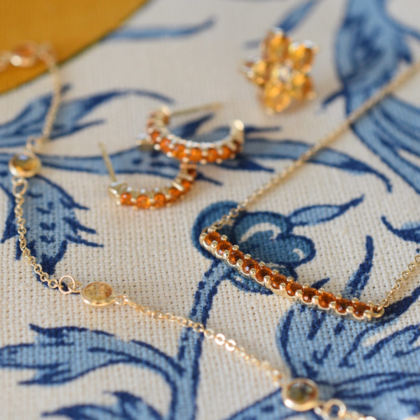 Assorted jewelry including a Rosecliff bar necklace & Rosecliff huggie earrings featuring 2 mm citrines prong set in 14k gold