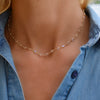 Woman with a Newport necklace featuring 4 mm briolette cut moonstones bezel set in 14k yellow gold
