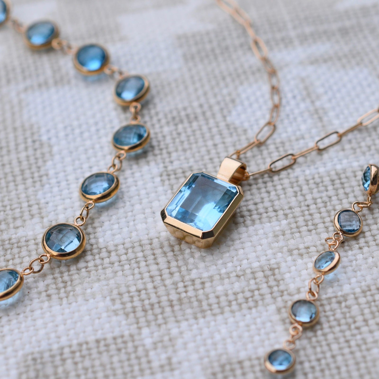 Adelaide paper clip chain with a Warren Nantucket blue topaz pendant in 14k yellow gold and Newport birthstone necklaces