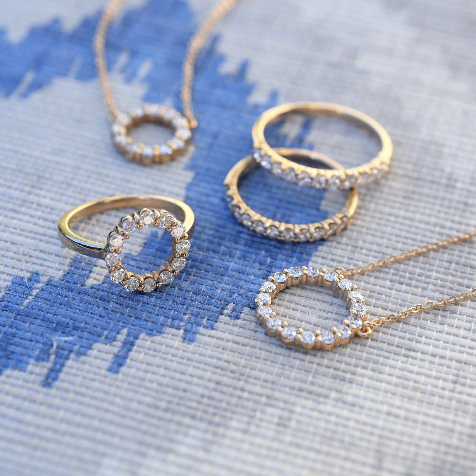 Rosecliff jewelry including an open circle necklace with sixteen 2 mm faceted round cut diamonds prong set in 14k gold