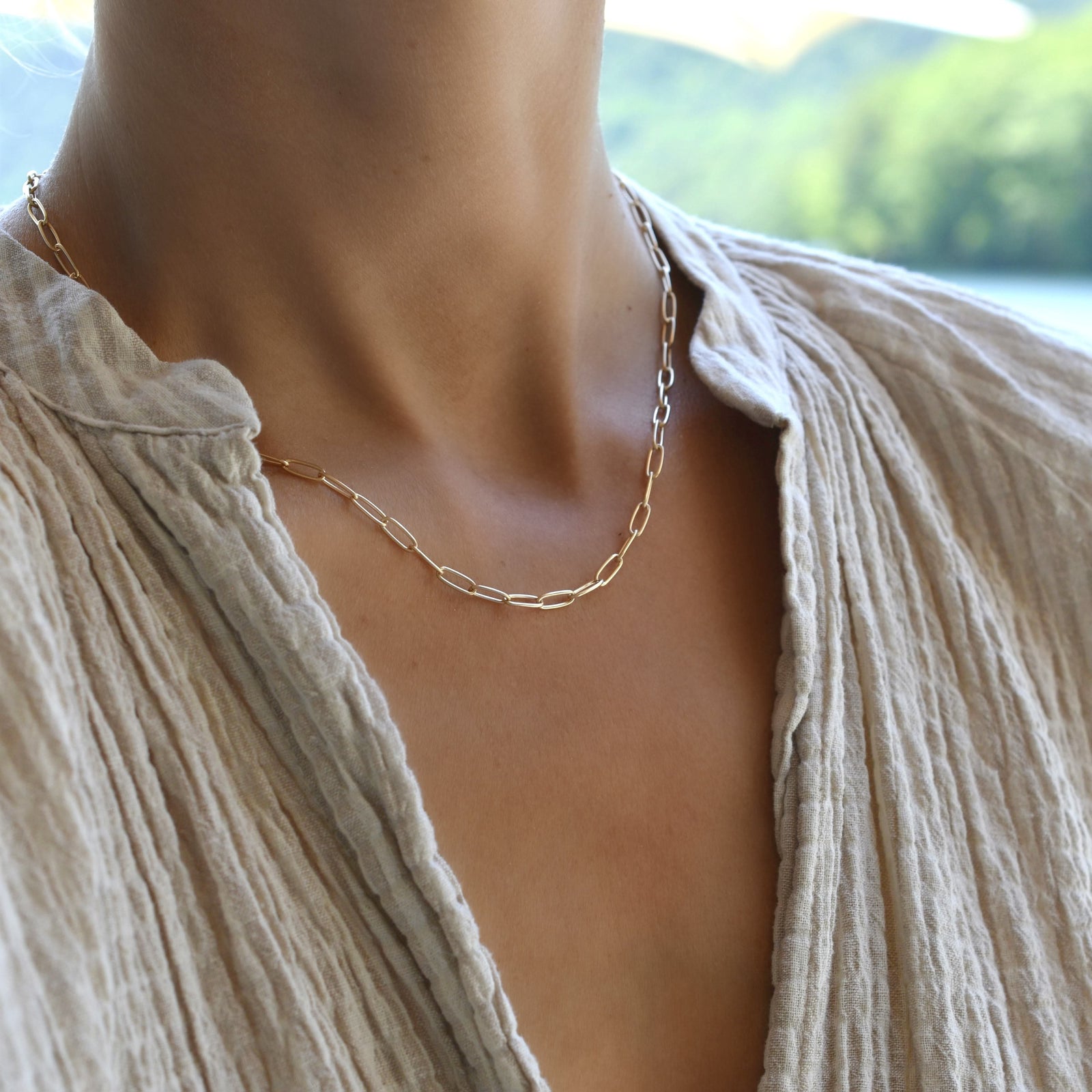 Woman wearing a 14k yellow gold Adelaide mini necklace featuring 8.4 x 3 mm paperclip chain links