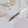 Providence vertical bar pendant necklace featuring 6 petite Sapphire baguette stones set in 14k gold