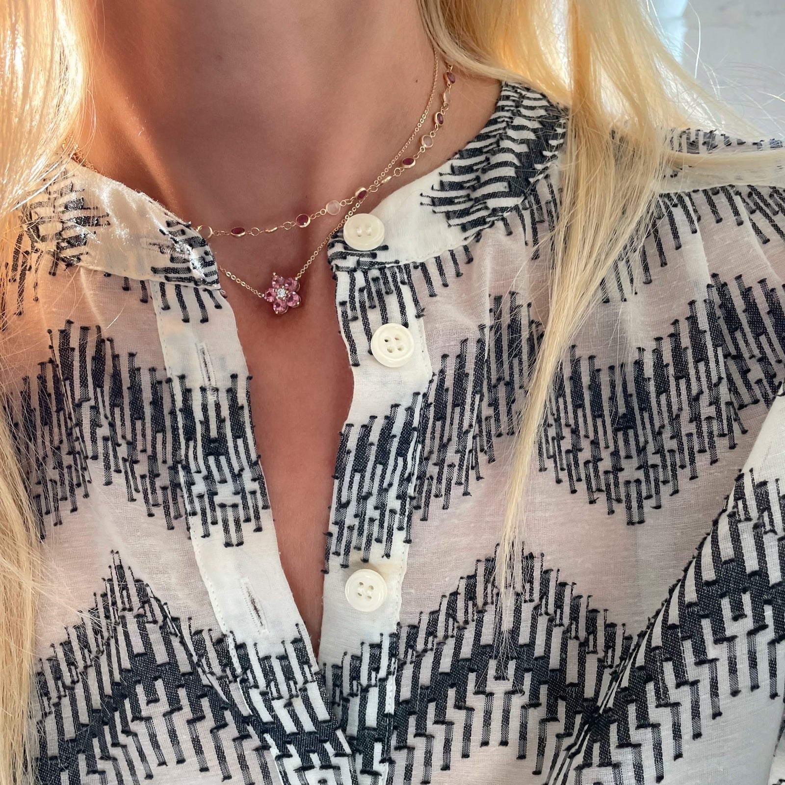 Woman with two 14k gold necklaces including a Greenwich necklace featuring five 4 mm pink tourmalines and one 2.1 mm diamond