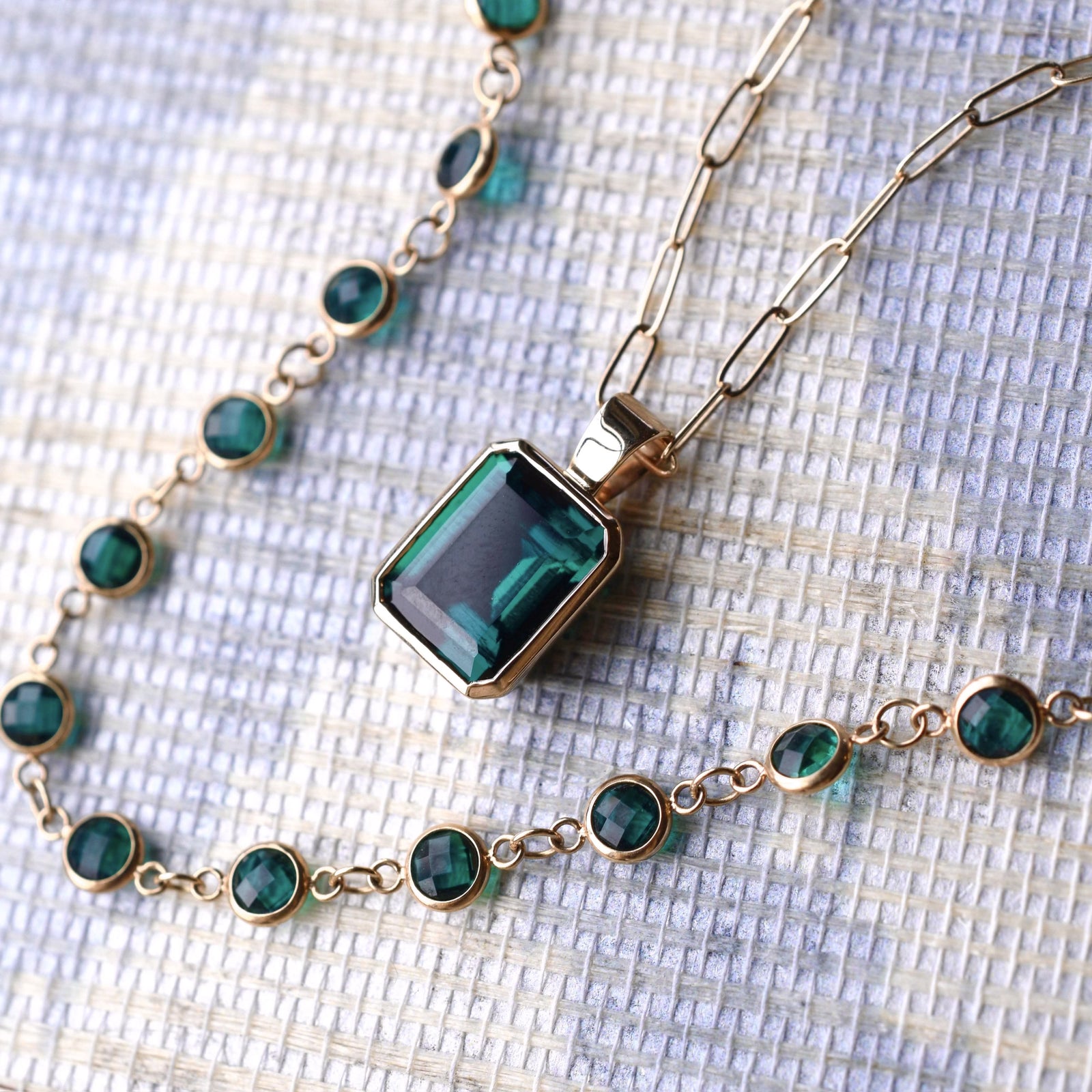 Adelaide paper clip chain with a Warren emerald pendant in 14k yellow gold and a Newport emerald necklace