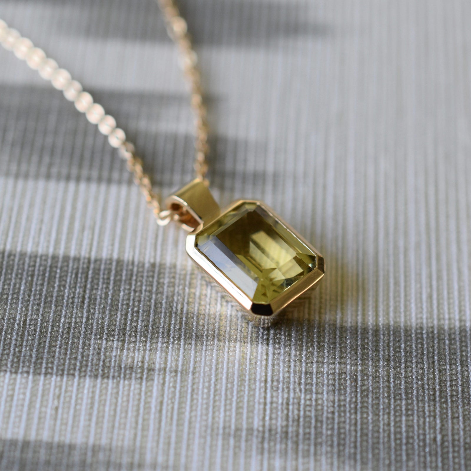 Adelaide paper clip chain and a Warren pendant with an emerald cut lemon verbena quartz gemstone in 14k gold