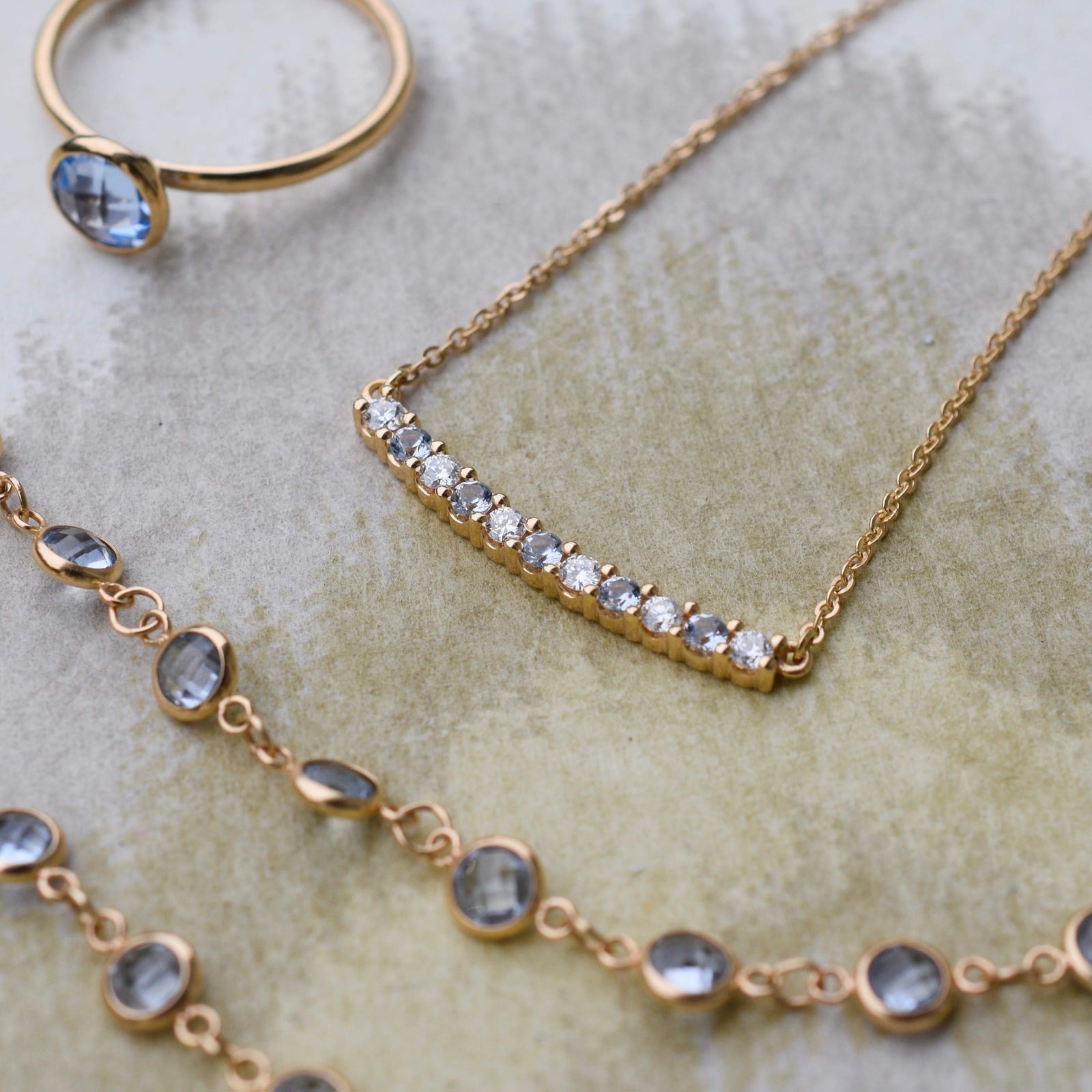 Ring and several necklaces including a gold Rosecliff bar necklace with eleven alternating 2 mm aquamarines and diamonds