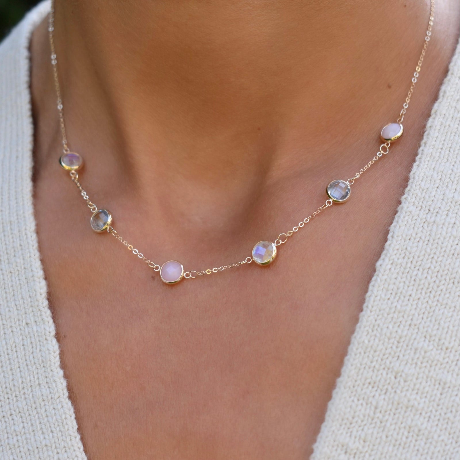 Woman with a Grand 14k gold 1.17 mm cable chain necklace featuring six 6 mm briolette cut bezel set gemstones