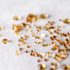 Loose citrine gemstones in various cuts on a white fabric background