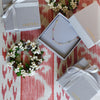 Plaid table cloth with wrapped Christmas presents and silver tray with 3 HAVERHILL jewelry boxes tied with gray ribbons