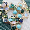 Personalized Newport necklace featuring alternating moonstone, emerald, peridot, aquamarine, turquoise, and pink opal stones.