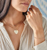 Woman wearing a Classic 3 Birthstone necklace & bracelet, & Engravable Large Flat Heart pendant with Adelaide chain.