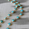 2 parallel strands of a Newport Grand Turquoise necklace featuring 6mm briolette cut, bezel set gemstones in 14k yellow gold.