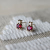 Pair of 14k yellow gold Greenwich Solitaire earrings, each featuring one 4mm briolette cut ruby and one 2.1mm diamond on top.