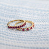 Two Rosecliff Ruby Stackable rings, one with alternating diamonds, featuring eleven 2mm faceted round cut gemstones.