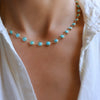 Woman wearing a Newport Grand Turquoise necklace featuring a continuous strand of 6mm briolette cut, bezel set gemstones.