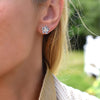 Woman wearing a 14k yellow gold Greenwich 5 Birthstone earring featuring five 4 mm Aquamarines and one 2.1 mm diamond