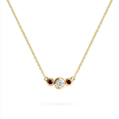 Barrington 3 Stone Necklace featuring a 4 mm round cut Diamond center stone framed by two 2 mm round cut Garnets bezel set in 14k yellow gold on a saffron chain – front view