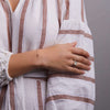 Woman wearing a Classic cable chain bracelet featuring one 4 mm briolette cut garnet bezel set in 14k yellow gold