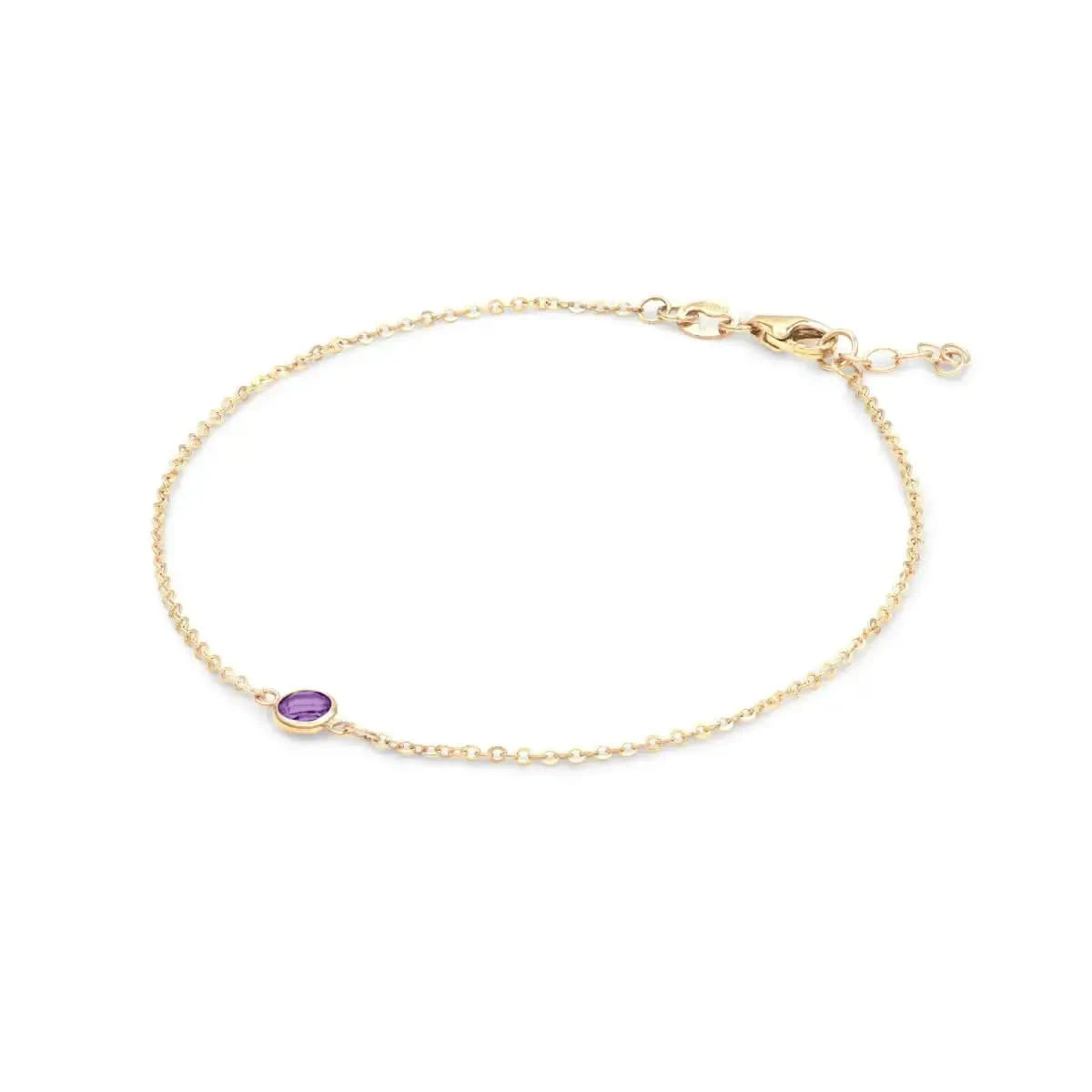 Classic cable chain bracelet featuring one briolette cut amethyst bezel set in 14k yellow gold - angled view