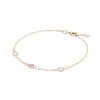 Pink Awareness Bracelet featuring two Moonstones and one Pink Sapphire bezel set in 14k yellow gold - angled view