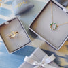 Two Haverhill signature gift boxes featuring a Warren birthstone ring with accent diamonds and a Rosecliff Circle necklace.