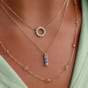 Woman wearing a Rosecliff Small Circle Diamond necklace, Providence 3 Sapphire pendant, & Bayberry 11 White Topaz necklace.