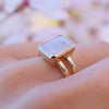 Woman wearing a Warren Rainbow Moonstone ring featuring a 10x8mm center stone and 6.5mm to 3.5mm tapered split band.