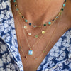 Woman wearing two personalized necklaces, a 4 Letter necklace, and a Warren pendant on an Adelaide Mini chain.