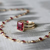 Warren Ruby ring in 14k yellow gold featuring a 10x8mm emerald cut, bezel set center stone, and a Newport Ruby necklace.