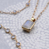 Warren pendant on an Adelaide Mini chain and Newport necklace, both featuring moonstone in 14k yellow gold.