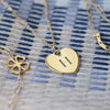 Clover Adelaide Mini bracelet, Flat Horseshoe necklace, and personalized Flat Heart pendant engraved with the letter H.