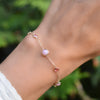 Wrist wearing a Grand & Classic 7 Pink Opal and Pink Tourmaline bracelet in 14k gold on a 1.17mm cable chain.