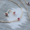 Assorted jewelery including a pair of Birthstone Stud Earrings featuring 4 mm Pink Tourmalines bezel set in 14k yellow gold