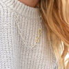 Blonde woman wearing a Hudson Necklace in Silver featuring 22.25mm chain links and three accent 18k gold bonded links.
