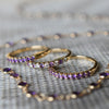 Three Rosecliff Stackable Amethyst rings in 14k yellow gold. The middle ring has alternating diamonds.