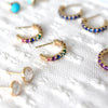 Pair of Rainbow Rosecliff earrings, Rosecliff Sapphire earrings, Grand White Topaz earrings, & a Rosecliff Amethyst earring.