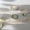 Rosecliff Circle necklace, Greenwich Solitaire ring, Rosecliff rings, & Adelaide 1 Pavé Link necklace featuring emeralds.