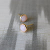 Pair of Grand Pink Opal Stud earrings bezel set in 14k yellow gold featuring a 6mm briolette cut gemstone.
