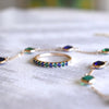 Terra Rosecliff Stackable ring and Terra 9 Birthstone necklace featuring alternating sapphire and emerald gemstones. 