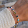 Personalized Newport Grand bracelet featuring 6mm alternating turquoise, sapphire, Nantucket blue topaz, peridot, & emeralds.