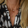 Woman wearing a personalized Adelaide 5 Pavé Link necklace and Warren Lemon Verbena Quartz pendant in 14k yellow gold.