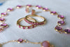 Two Pink Tourmaline Rosecliff Stackable rings, one with alternating diamonds, and a Newport Grand Pink Sapphire necklace.