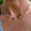 Personalized Grand 9 Birthstone necklace featuring alternating emeralds and moonstones on a 1.17mm cable chain.