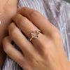 A hand wearing a Rosecliff Small Circle Rainbow ring featuring twelve 2mm prong set gemstones with alternating diamonds.