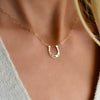 Woman wearing a Flat Horseshoe necklace with Adelaide Mini chain featuring an 11.81x13.12mm cutout horseshoe.