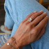 Woman's hand wearing a MOM bracelet, Bayberry bracelet, Rosecliff Stackable ring & Warren Horizontal ring in 14k yellow gold.