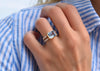 Woman's hand wearing a Warren Horizontal ring with diamonds featuring a 10x8mm Nantucket blue topaz center stone.