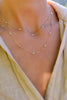 Woman wearing a Bayberry Wrap necklace featuring 4mm moonstones. The necklace is wrapped twice, creating two layers.