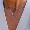 Woman wearing three Haverhill necklaces: Personalized Rosecliff Circle Birthstone necklace, Personalized Diamond Newport Grand necklace, and Personalized Rainbow 7 stone necklace.